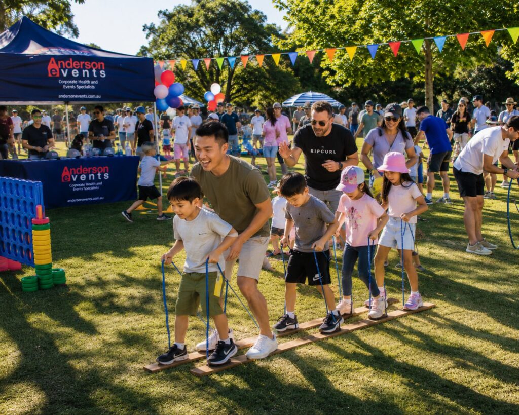 Corporate Year End Events Sydney 9 Staff and their kids take part in a relay game at a year end family fun day in a Sydney park